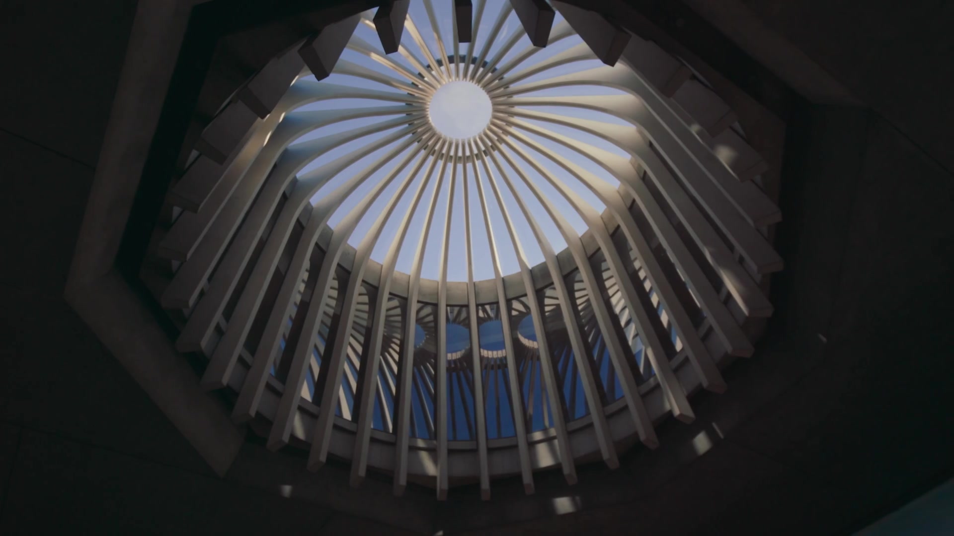 Light filtering through a circular architectural ceiling