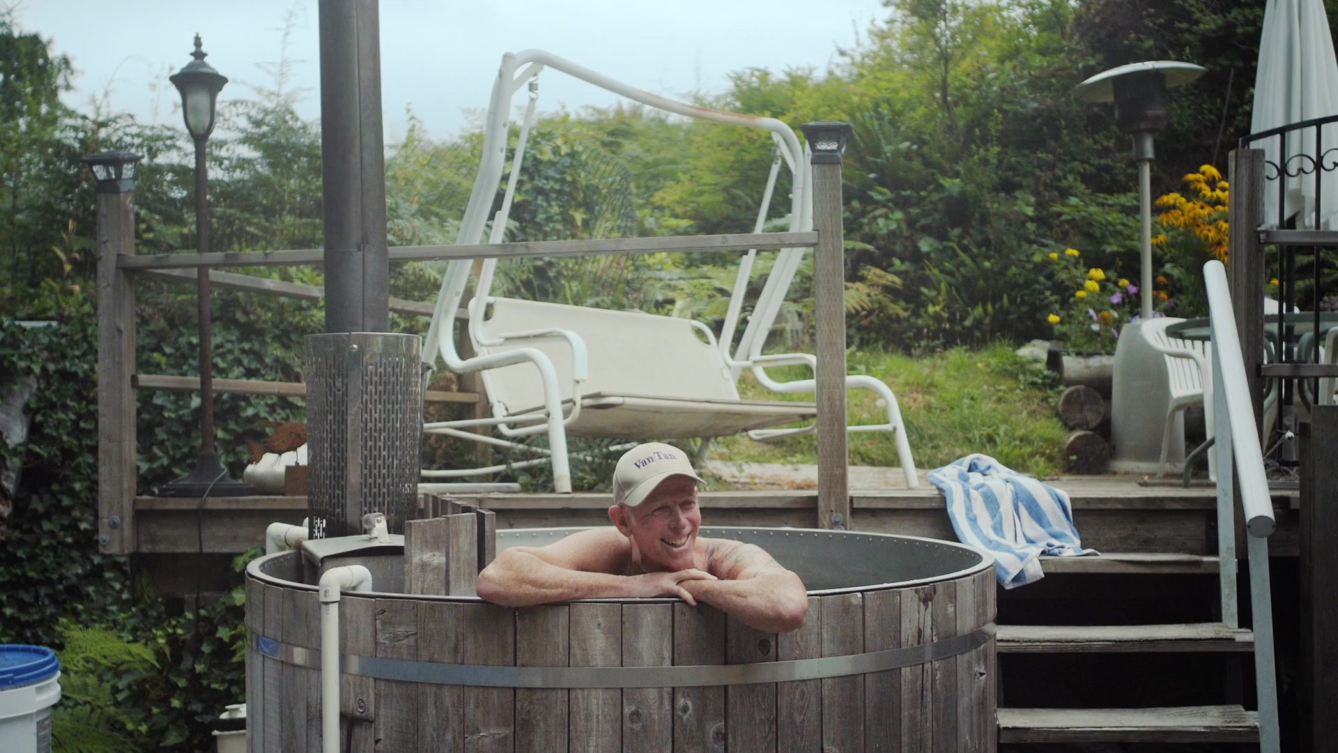 A Van Tan Club member relaxing in an outdoor pool surrounded by forest