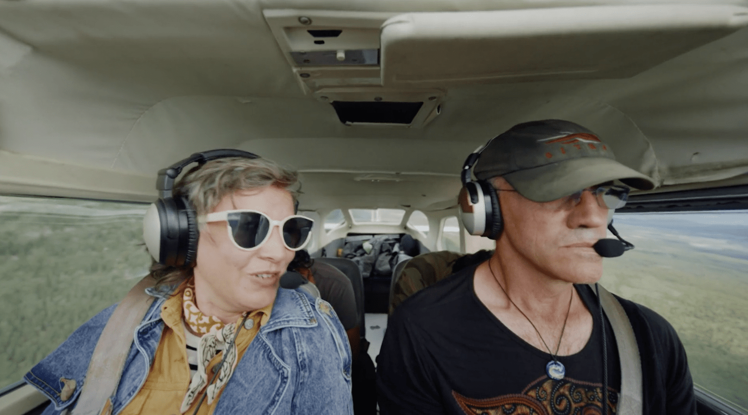 Christa Couture wearing a headset beside a pilot
