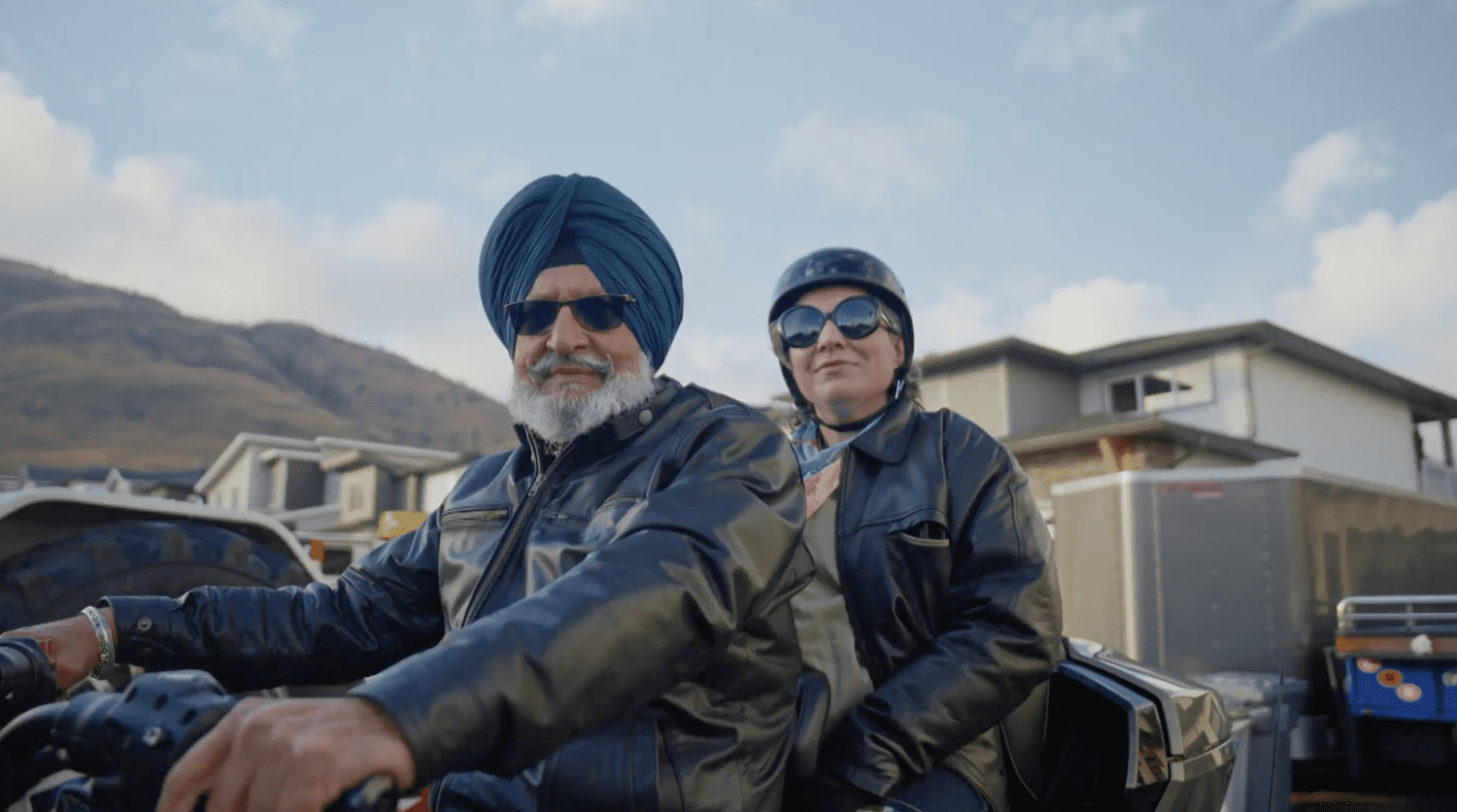 Christa Couture riding on a motorcycle with a local guide