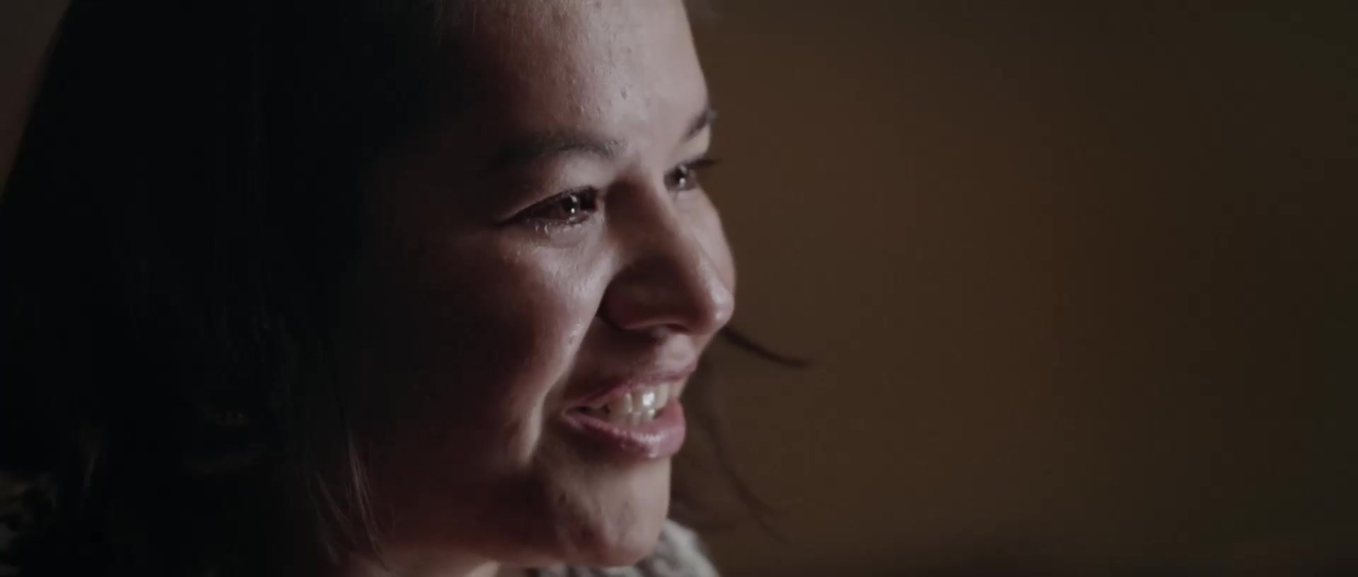 Cezin Nottaway smiling in warm window light
